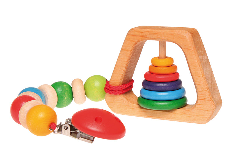 Grimm's Grasping Pyramid Rattle attached to a pacifier chain