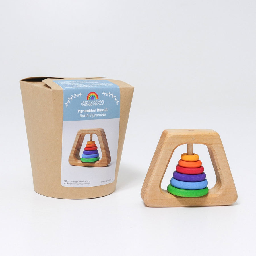 Grimm's Grasping Pyramid Rattle next to its cardboard packaging box