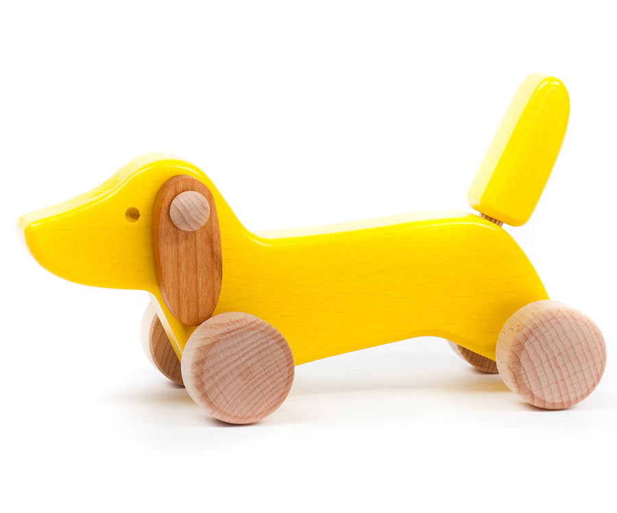 Bajo handmade yellow wooden dachshund puppy toy on a white background