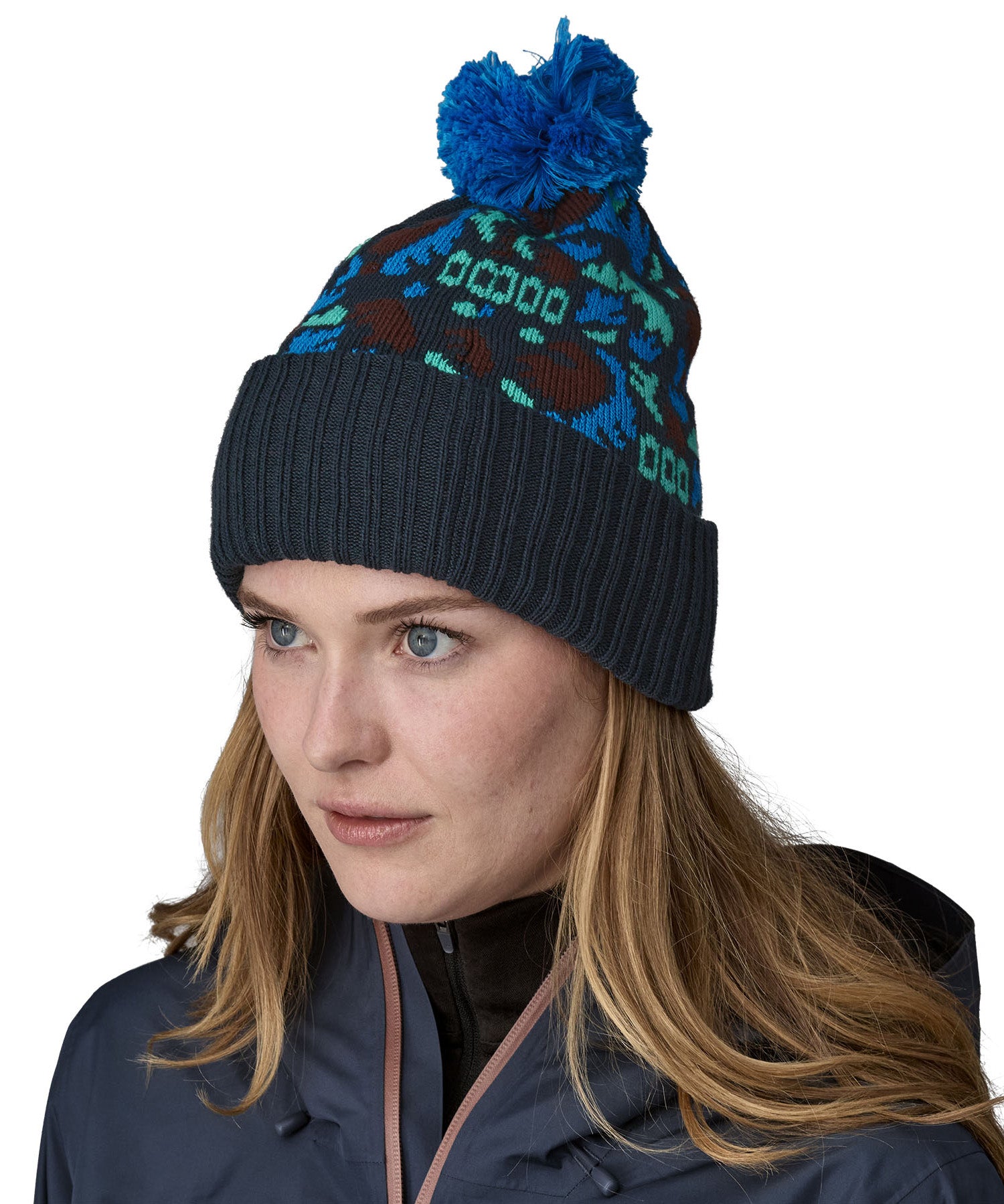 A female adult wearing the blue Patagonia bobble beanie.