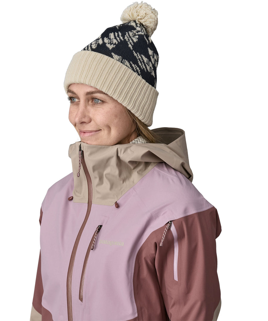 A female adult wearing the blue and cream Patagonia bobble beanie.