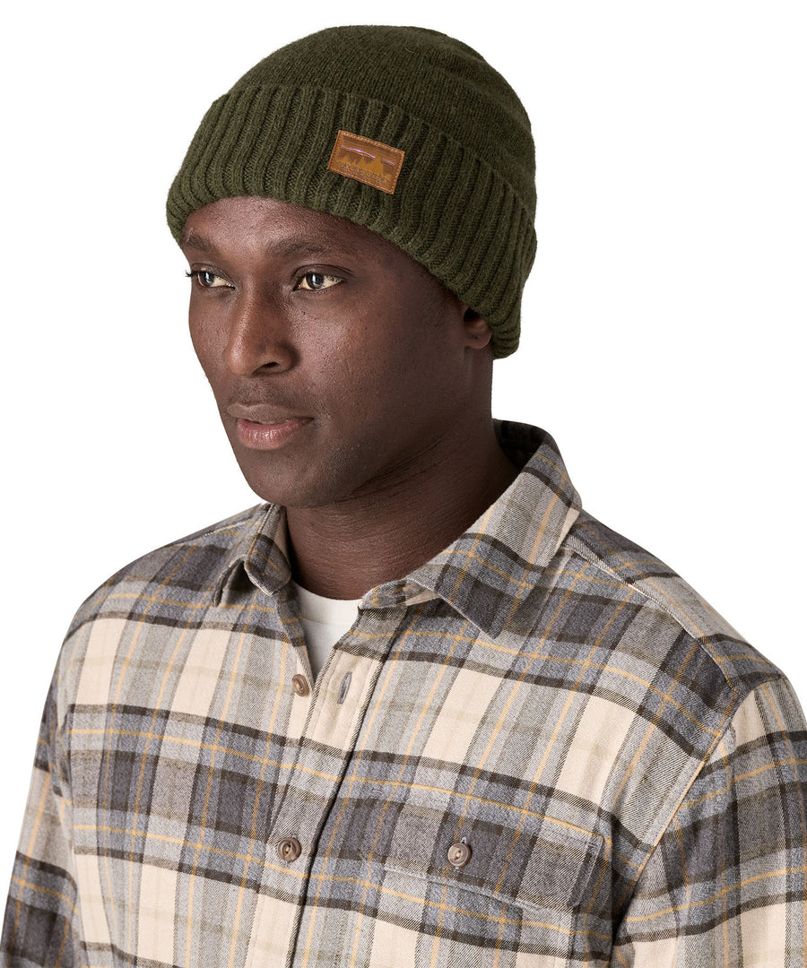 A male adult wearing the green beanie.