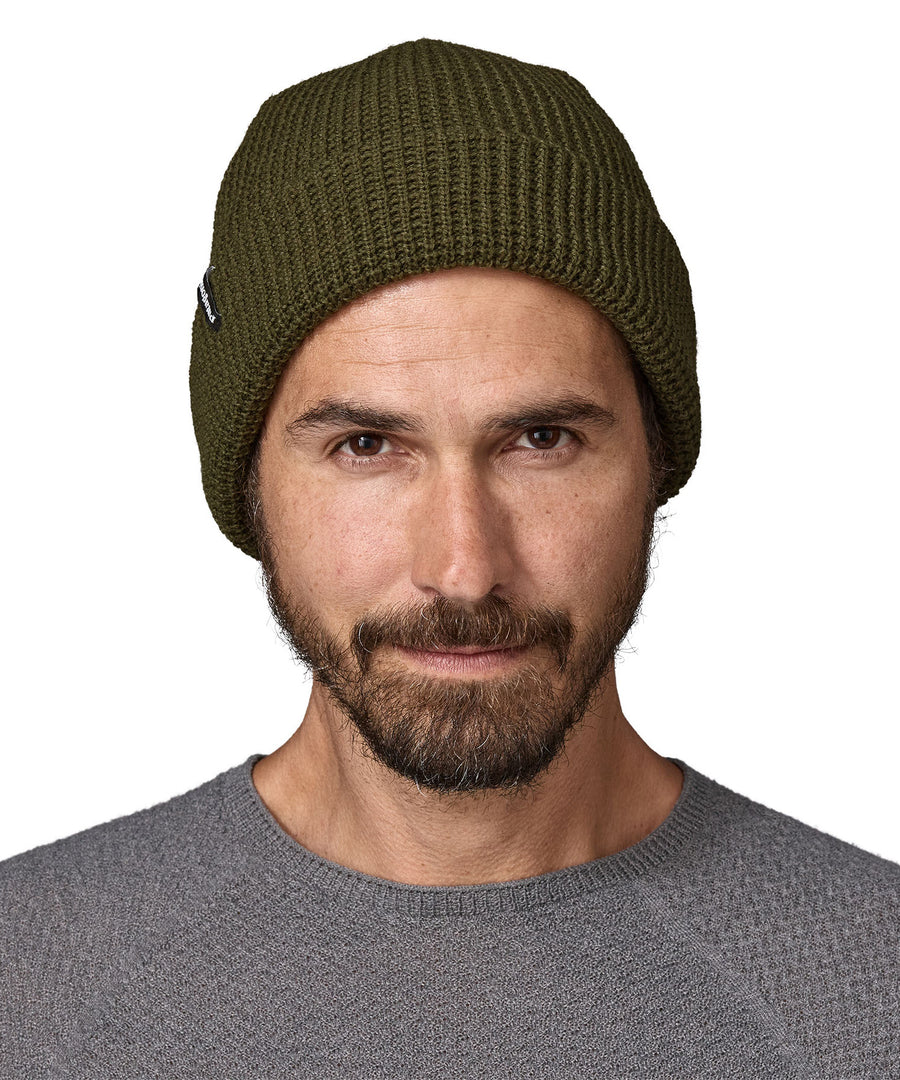  A Male adult wearing the dark green Patagonia beanie.