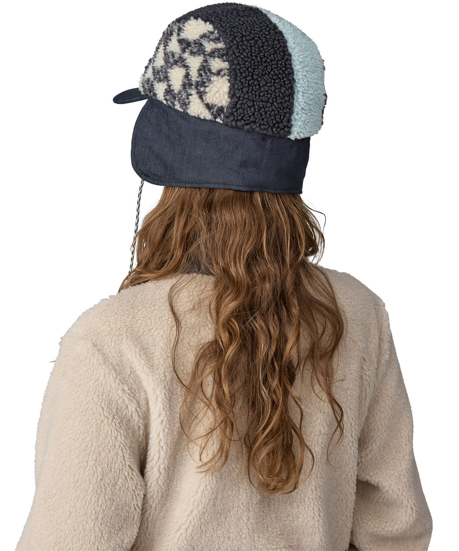 The back of the blue fleeced Patagonia earflap cap