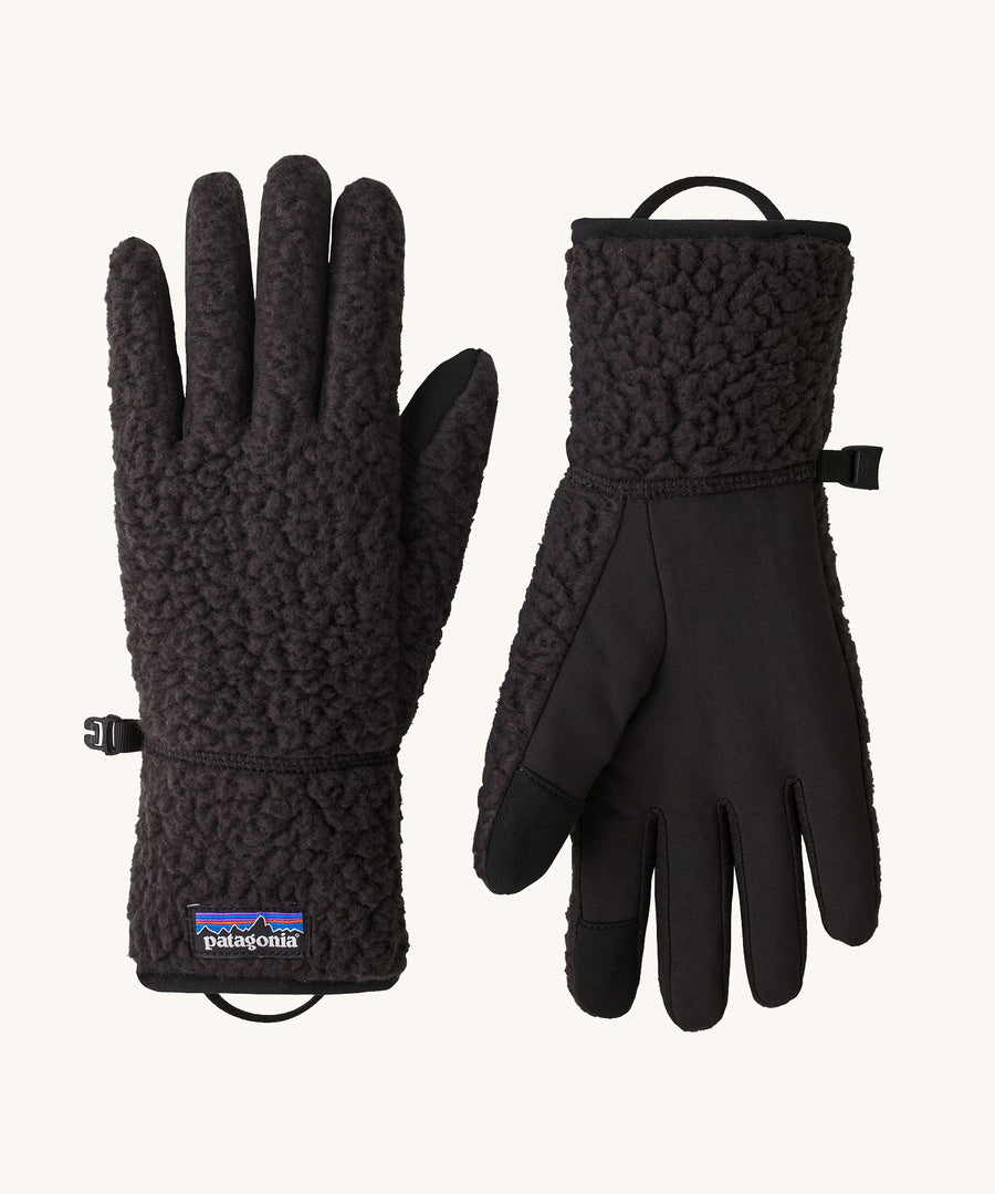 A pair of black Patagonia fleeced gloves on a cream background.