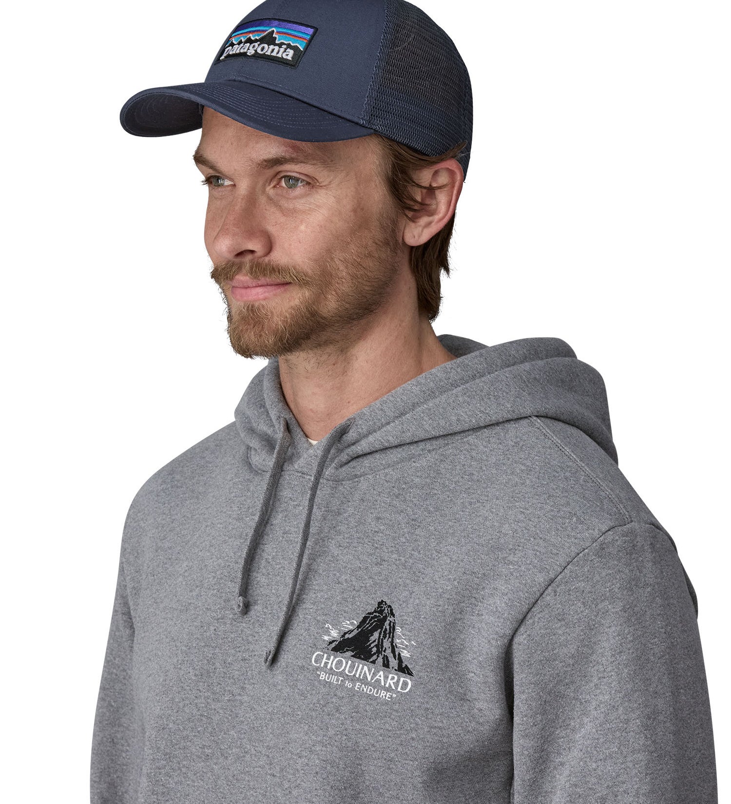 A male adult wearing the navy Patagonia trucker hat.