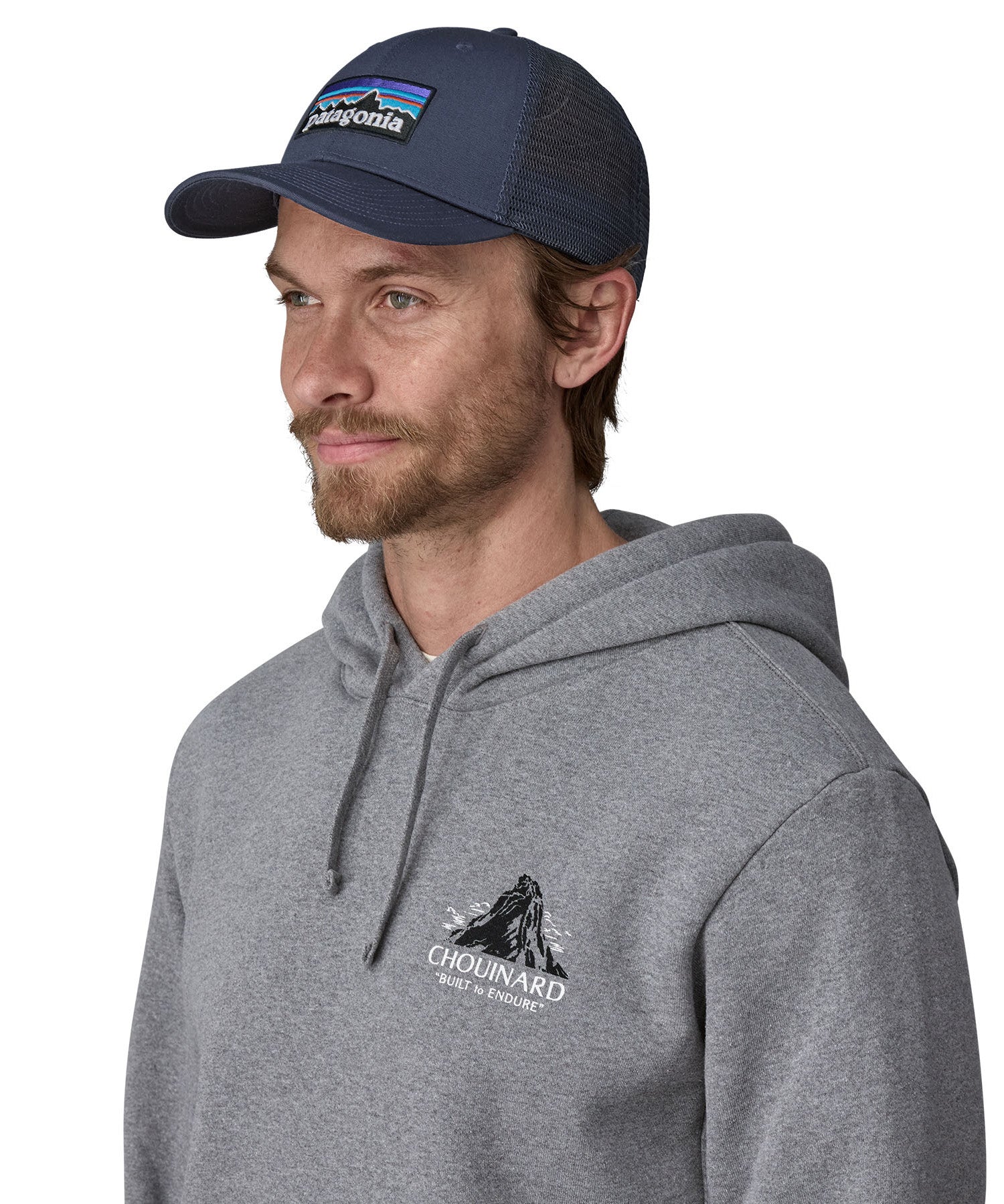 A male adult wearing the navy Patagonia trucker hat.