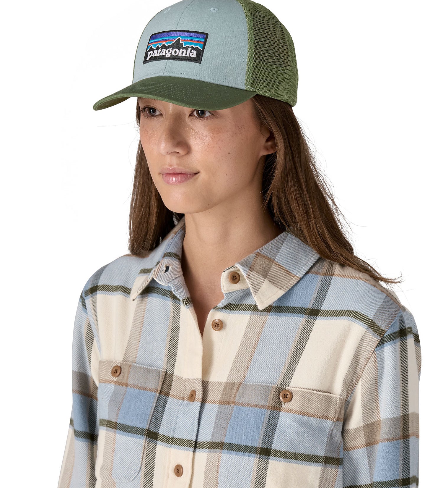 A female adult wearing the light blue and green Patagonia trucker hat