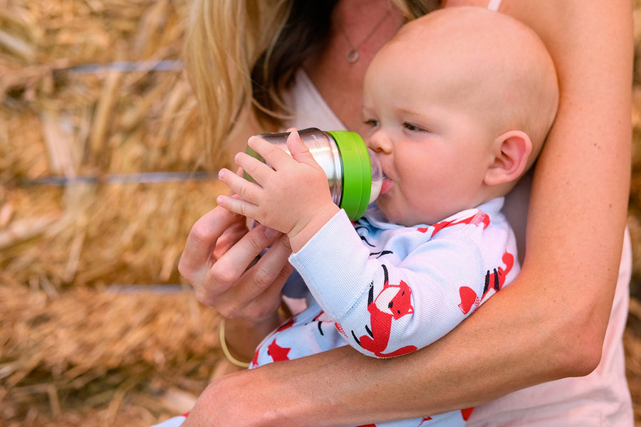 Close up of a baby drinking from the Kid Kanteen 5oz eco-friendly metal baby bottle