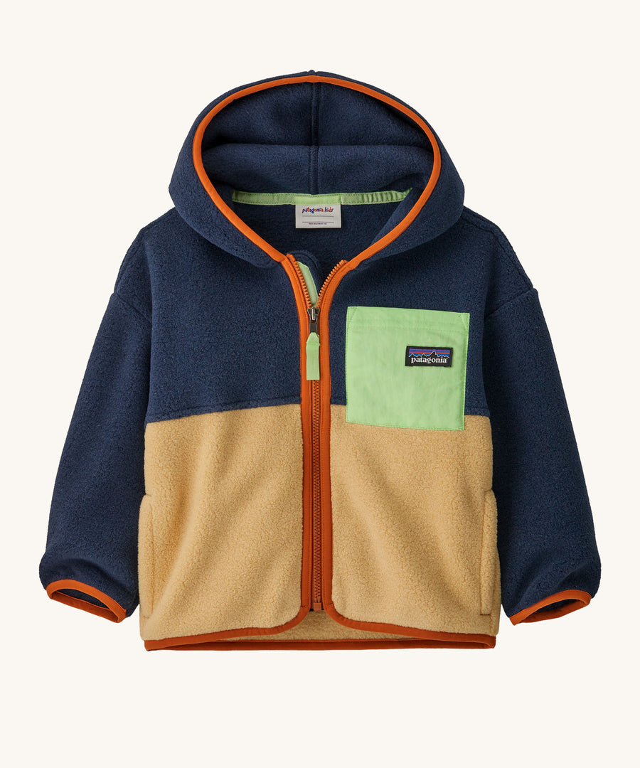 A navy and light brown hooded fleece with orange trim on a cream background.