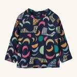 A navy fleece sweater with different coloured shapes on a cream background