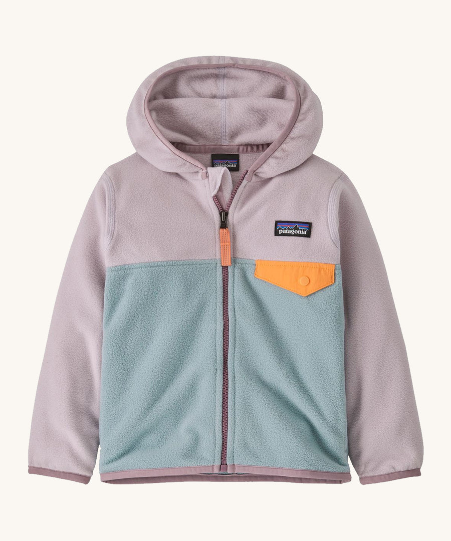 Light pink and blue kids Patagonia fleece on a cream background