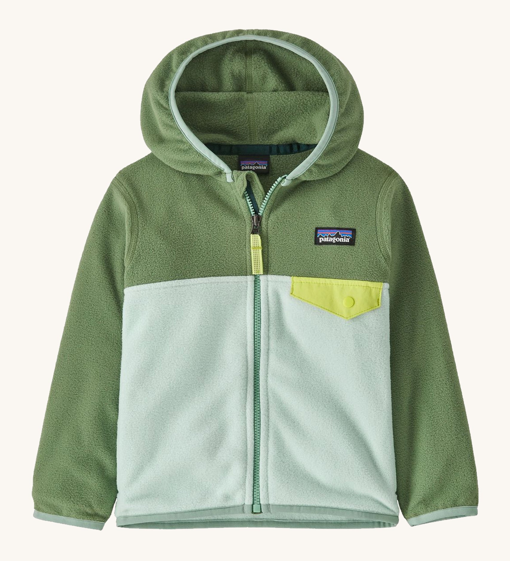 Green Patagonia fleece on a cream background