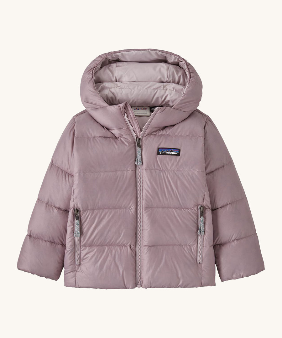 Light pink kids Patagonia down jacket on a cream background