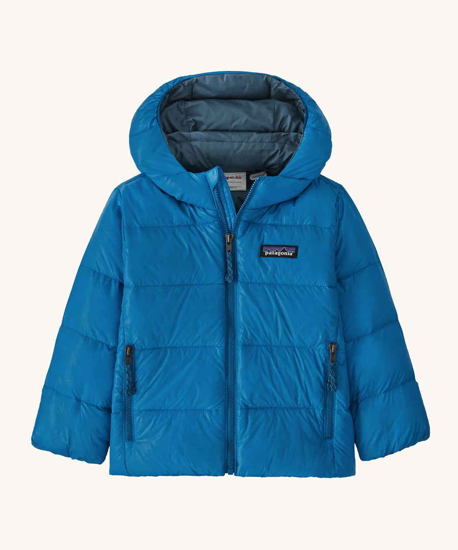 Light blue kids Patagonia down jacket on a cream background