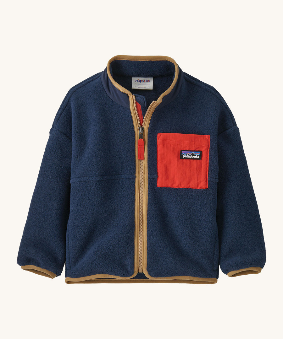 A navy with brown trim Patagonia fleece on a cream background