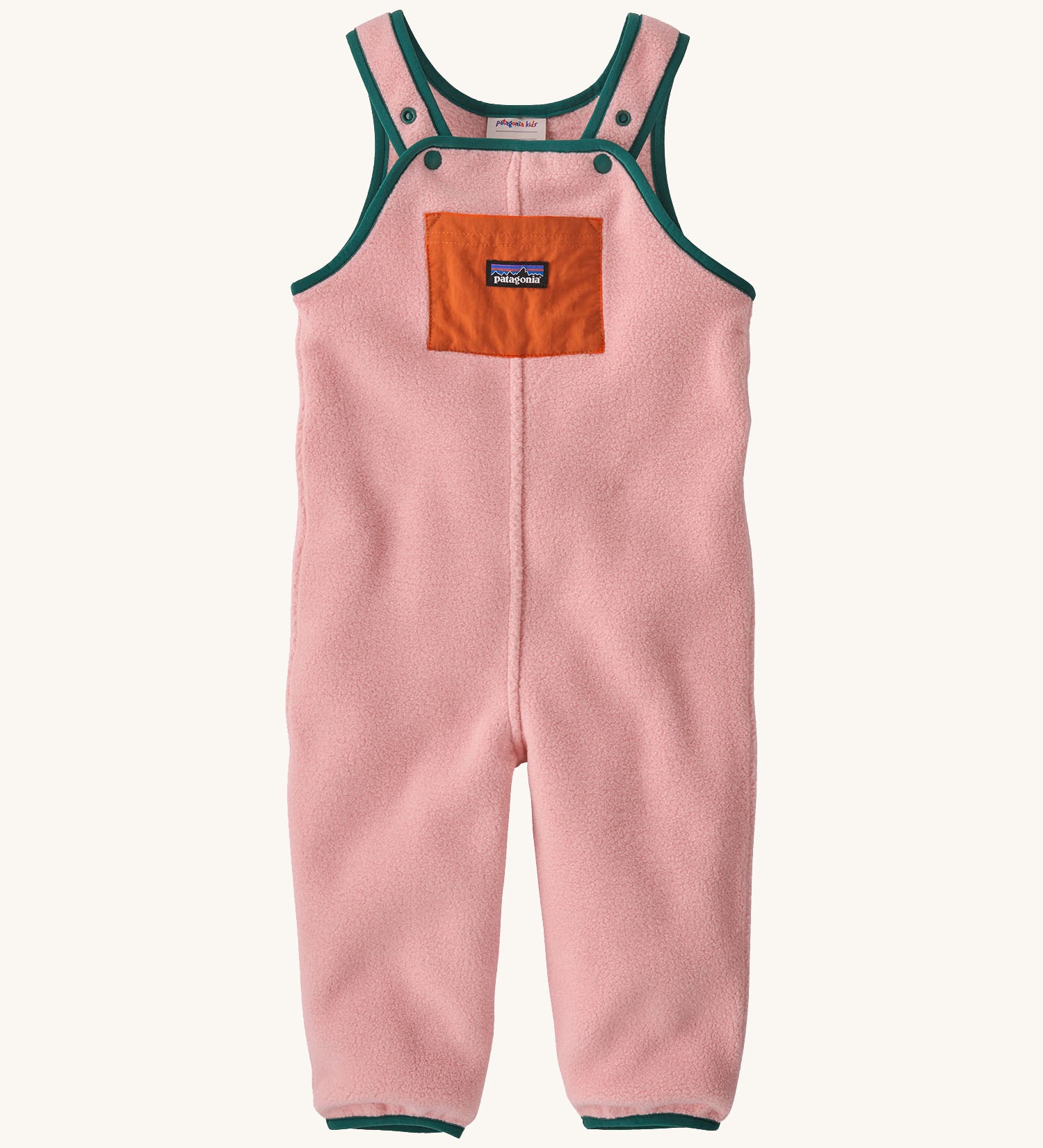 A pair of pink overalls with green trim on a cream background