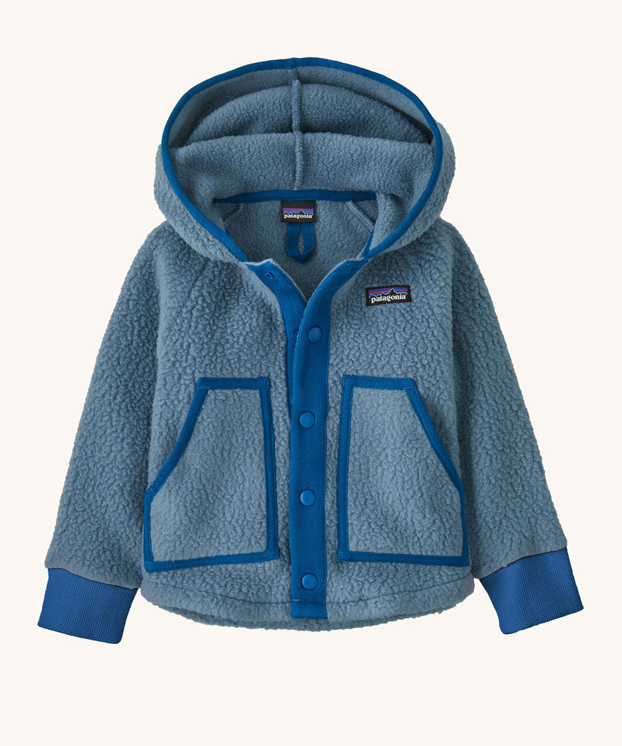 A blue hooded Patagonia fleece on a cream background