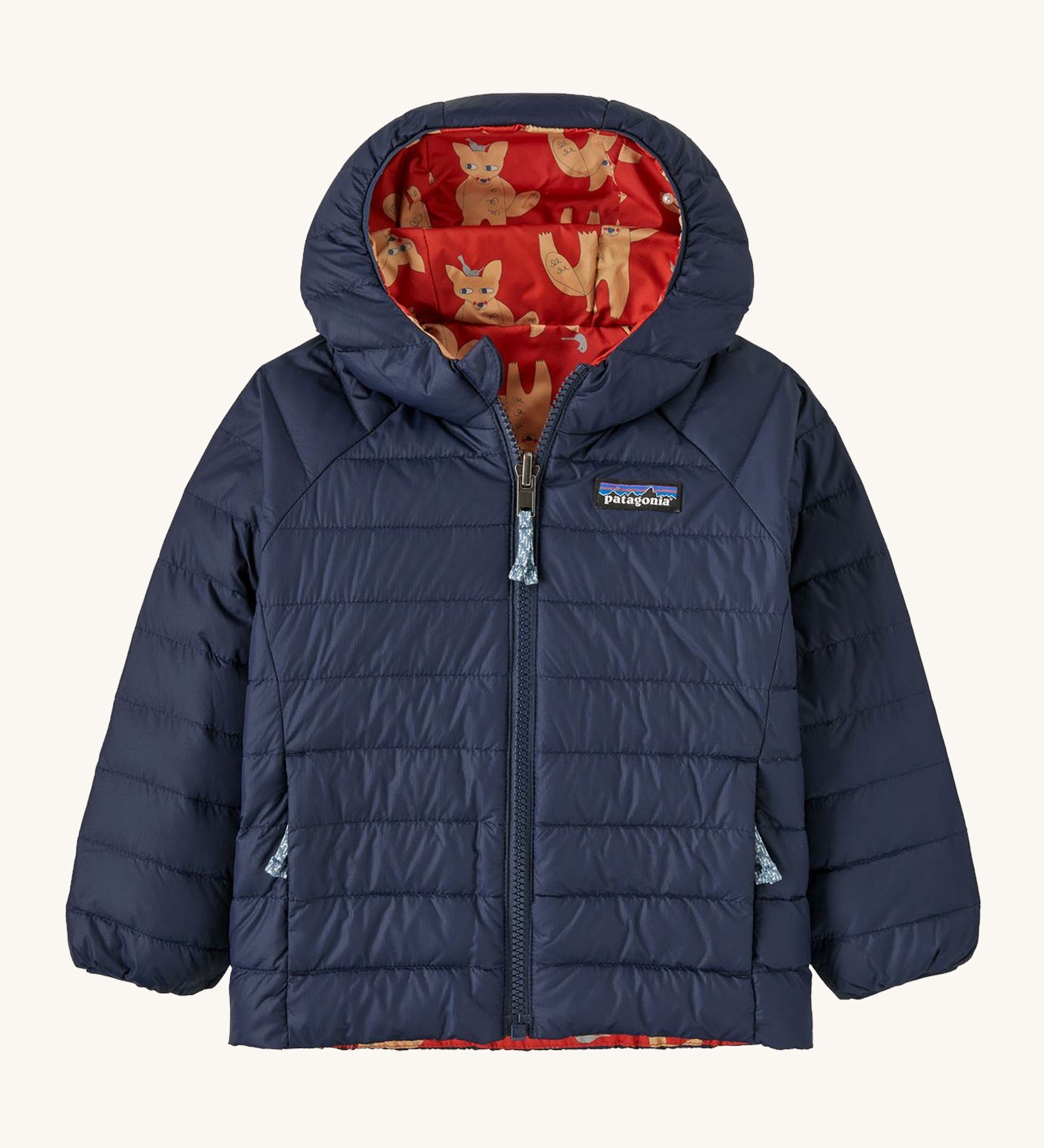 Navy Patagonia jacket with a fox reversible print on the inside on a cream background