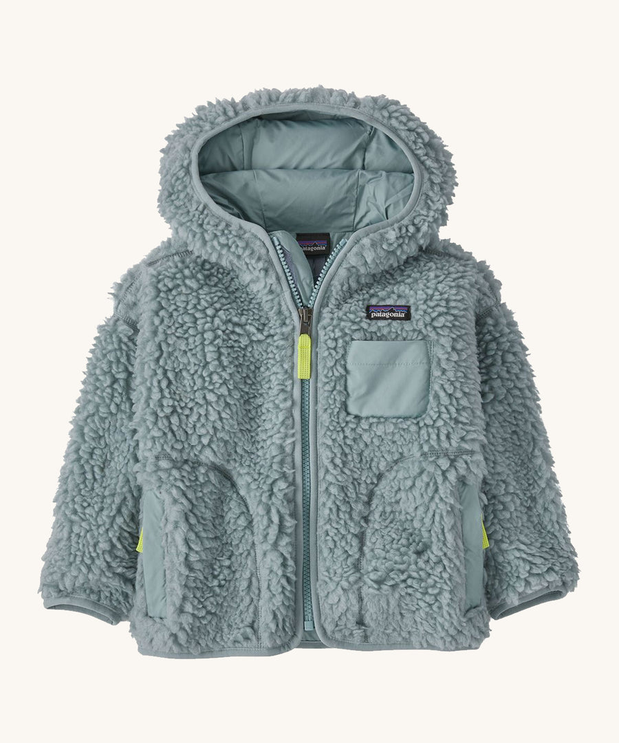 Light blue kids Patagonia fleece on a cream background