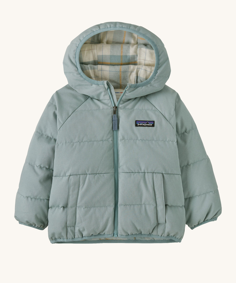 A light blue hooded jacket with a check design on the inside on a cream background