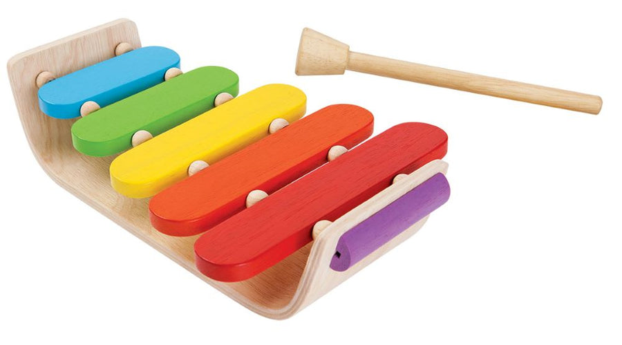 Plan Toys Oval Xylophone with rainbow keys and made from natural rubber wood. Sustainable musical instrument toys by Plan Toys. White background.