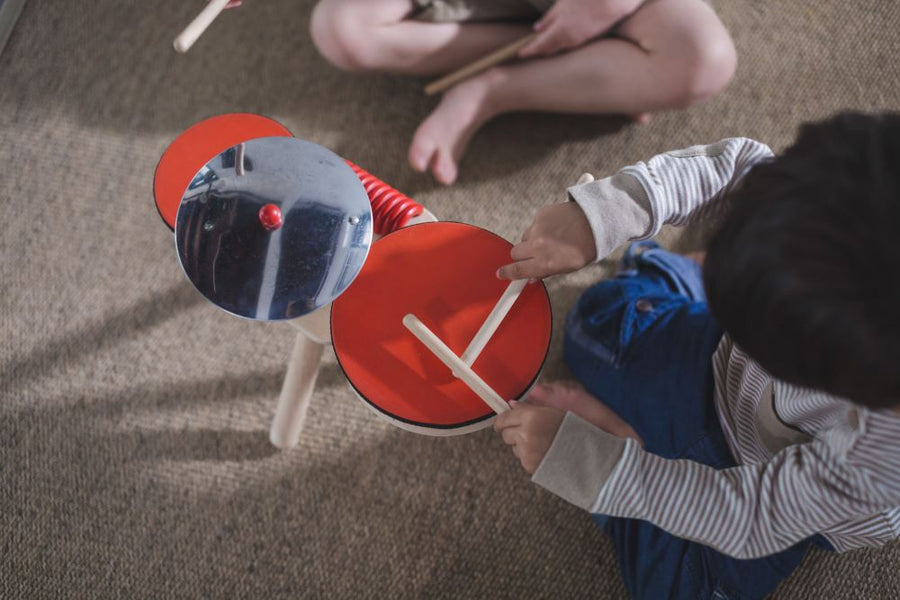 an eco-friendly and plastic-free wooden drum kit for toddler's on a white background.