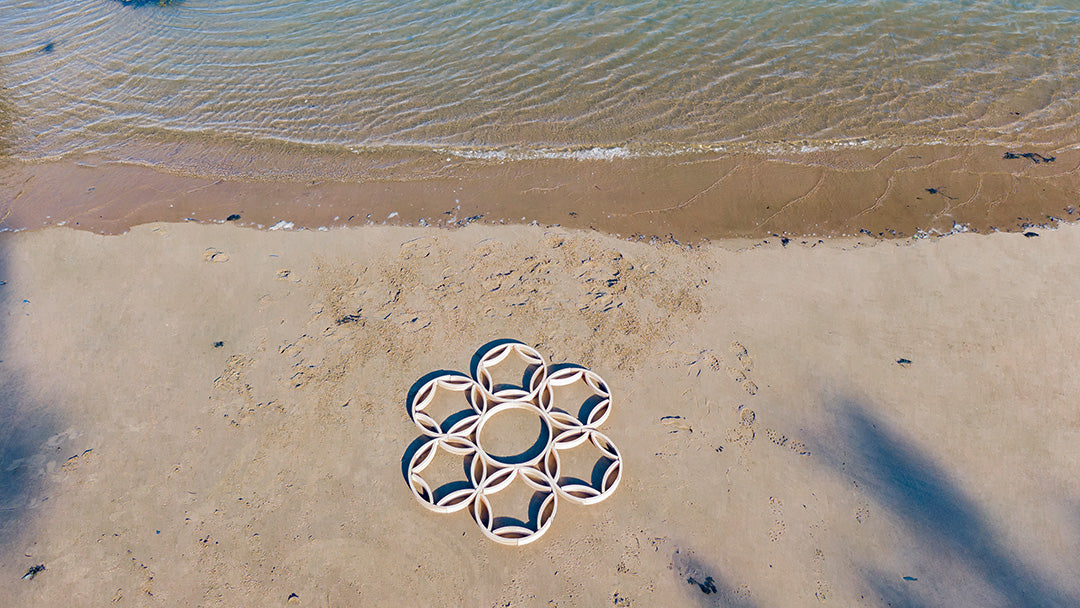 Abel blocks set up in geometric circles on the beach