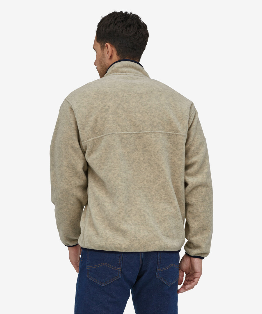 A person wearing the Patagonia Men's Synchilla Snap-T Fleece - Oatmeal Heather, showing the back of the fleece