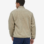 A person wearing the Patagonia Men's Synchilla Snap-T Fleece - Oatmeal Heather, showing the back of the fleece