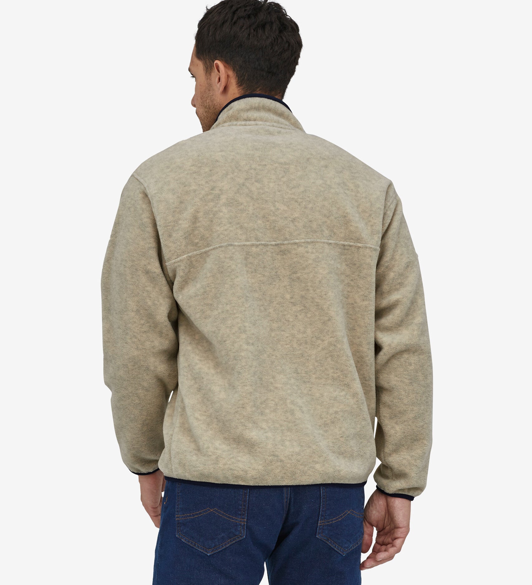 A person wearing the Patagonia Men's Synchilla Snap-T Fleece - Oatmeal Heather, showing the back of the fleece