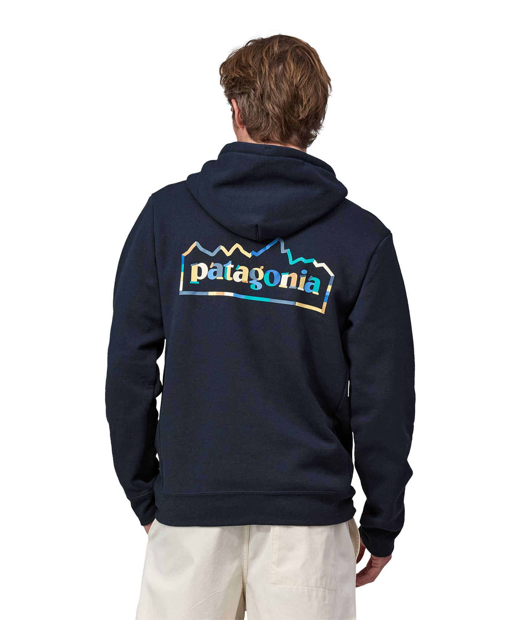 An adult showing the Patagonia Logo on the Patagonia Unity Fitz Uprisal Hoody - New Navy