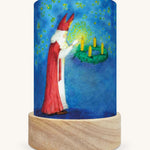 The Advent Light illustration by Eentje Van Margo sat in a Toverlux Magic Lantern base, on a cream background