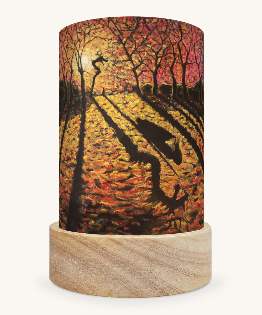 The Autumn Courage illustration by Kapitein Kalk sat in a Toverlux Magic Lantern base, on a cream background