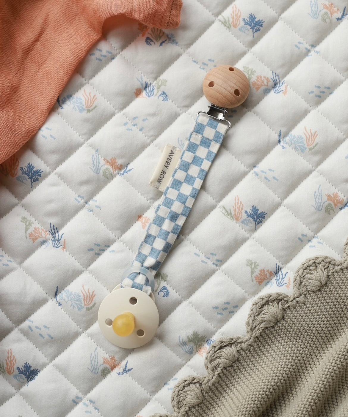 Avery Row Pacifier Holder - Waves. A blue and white check fabric on the Avery Row Waves/Coastline bedding