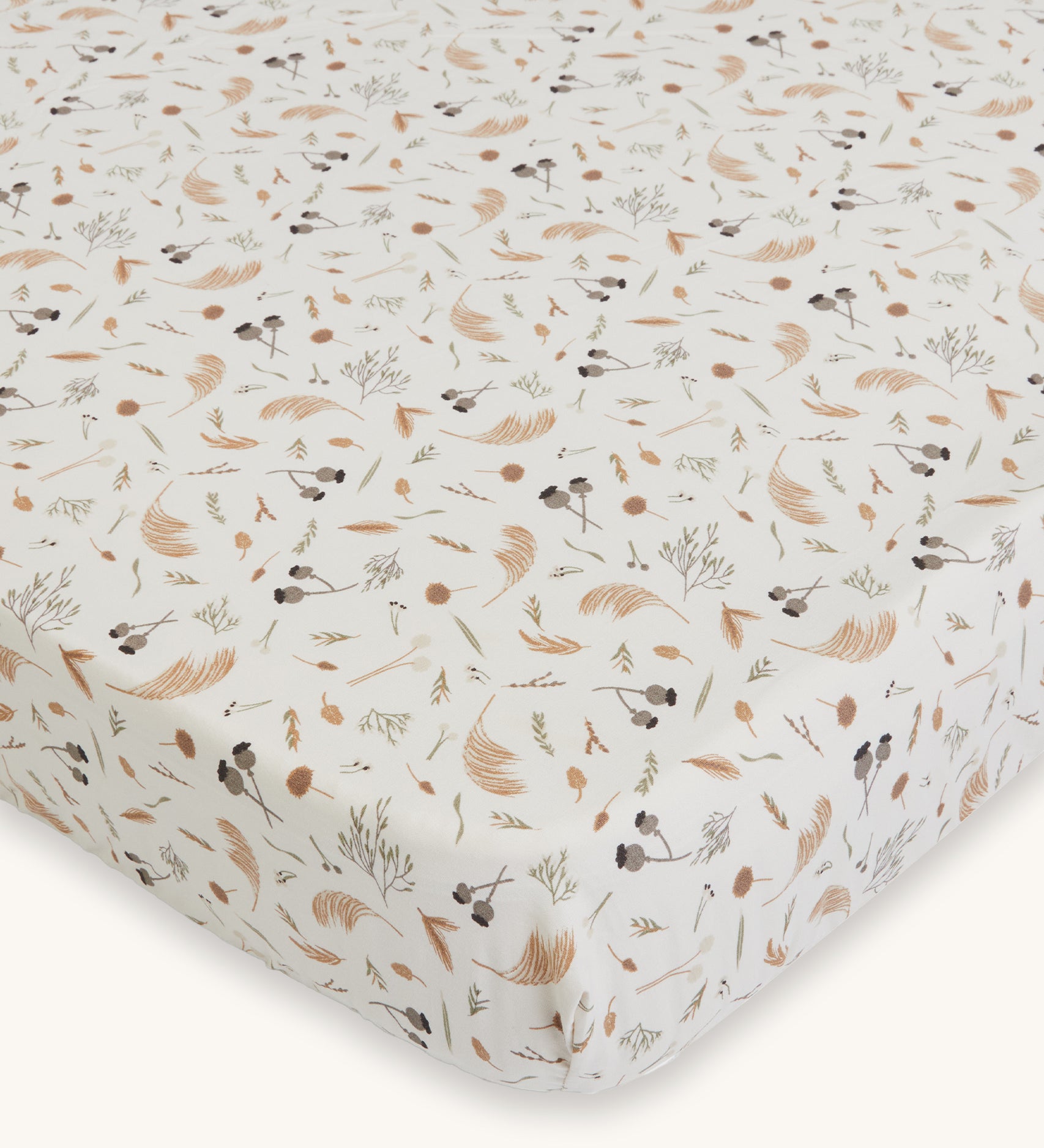 Avery Row Cotbed Fitted Sheet - Grasslands. A light cream fitted sheet with delicate grassland print