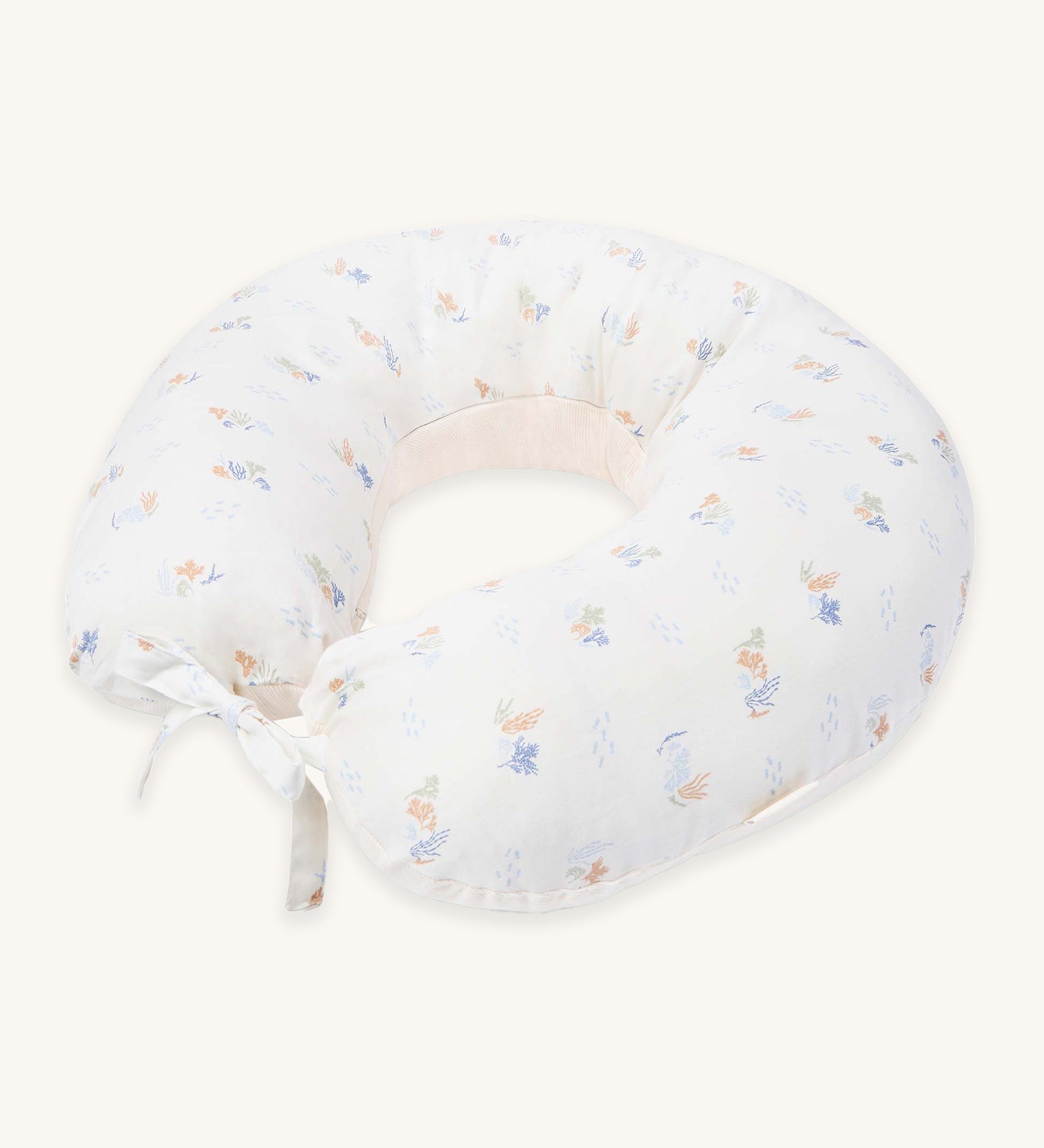 Avery Row Nursing Pillow - Coastline, a white nursing pillow with a delicate seaweed print in muted tones. 