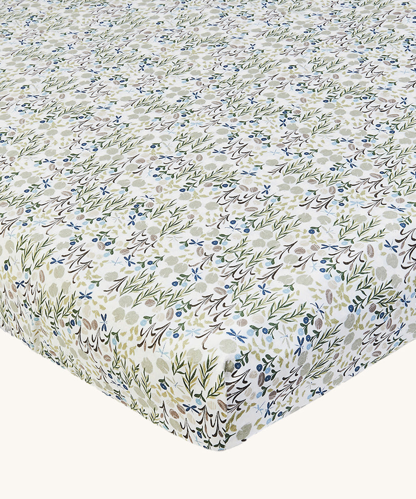 Avery Row Cotbed Fitted Sheet - Riverbank. A light cream sheet with beautiful and delicate Riverbank print