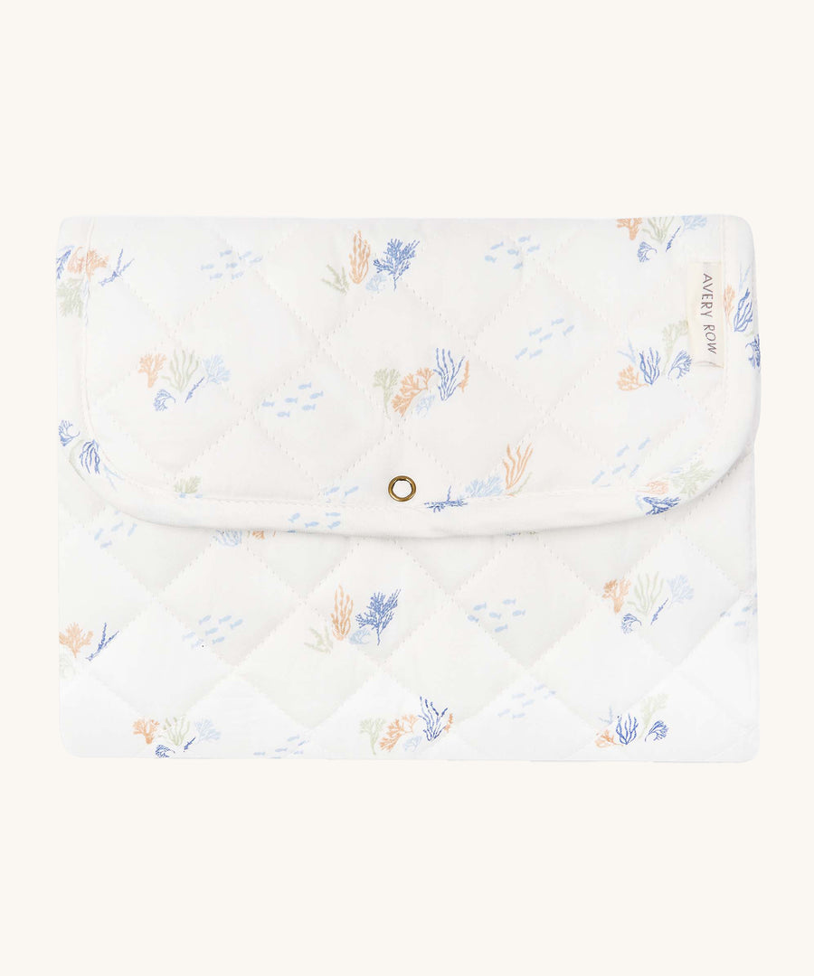 Avery Row Travel Changing Mat - Coastline, a white padded changing mat with delicate seaweed print in soft pastel tones.