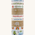 A tall stack of patterned paper tape on a cream background.