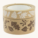 Babipur kraft eco paper tape in a stack with the white leaves print on top of the brown leaf print, on a cream background