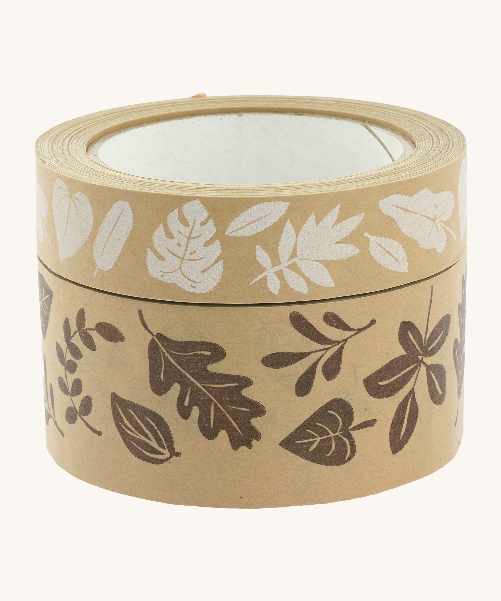 Babipur kraft eco paper tape in a stack with the white leaves print on top of the brown leaf print, on a cream background