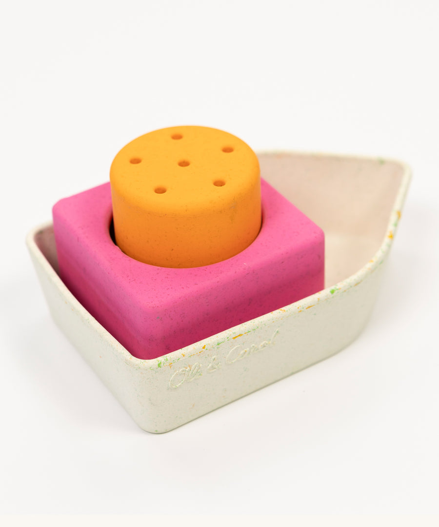 A closer look at the Oli & Carol Boat Bath Toy - Orange, on a cream background