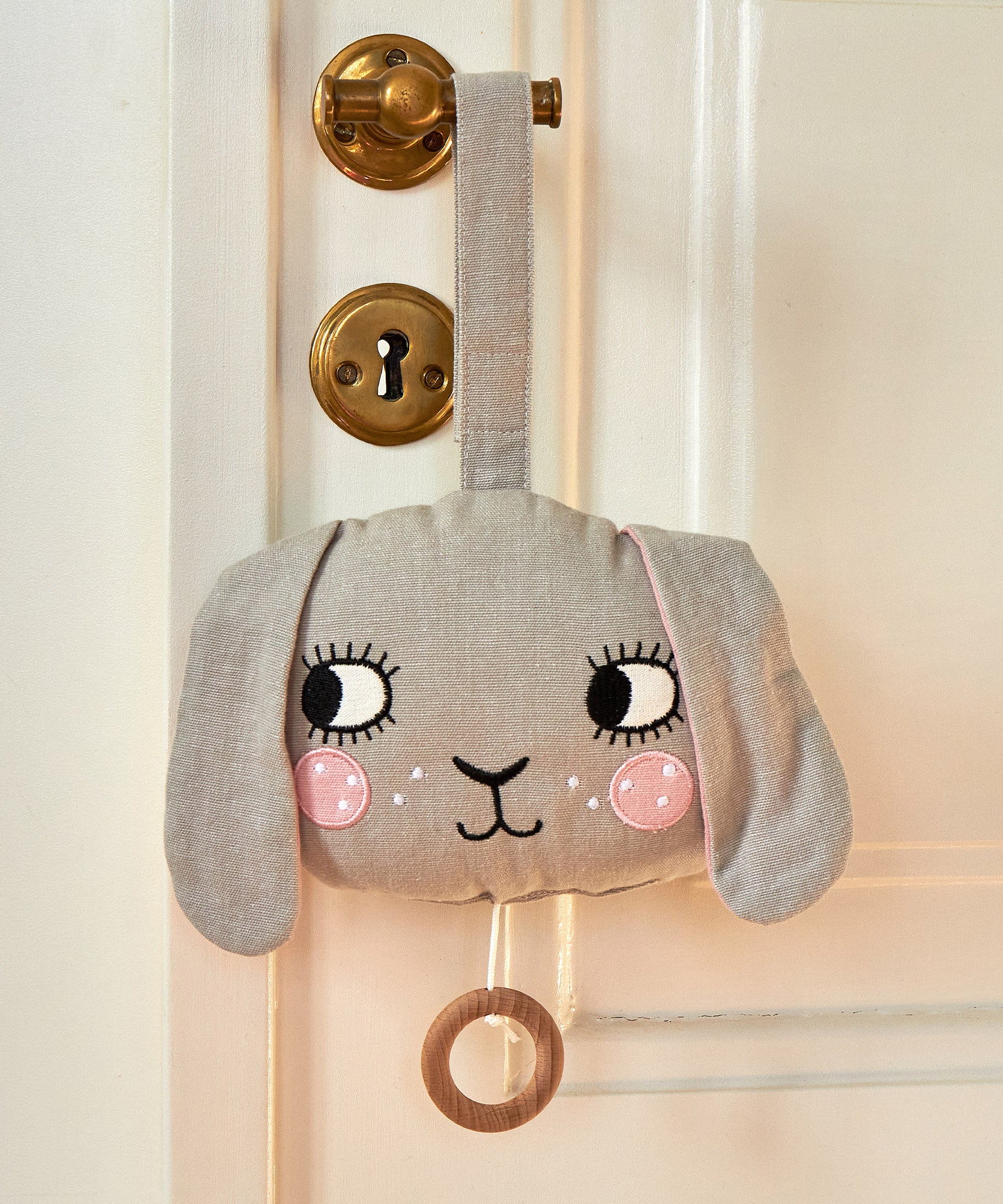 The Roommate Musical Baby Mobile - Bunny hung up on a brass door handle