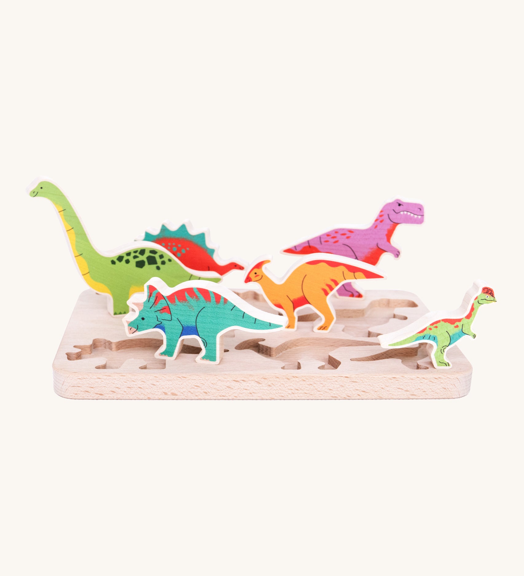 The Bajo Dinosaur Puzzle pieces stood up on their wooden base to show the thickness and the length of the dinosaurs, which are perfect for little children's hands