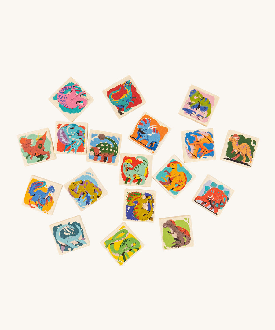 18 square pieces from the Bajo Dinosaur Memory Game, all showing colourful dinosaur images on a cream background