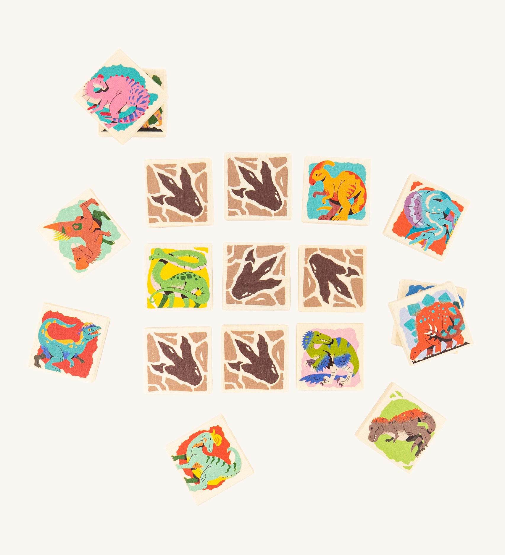 The Bajo Dinosaur Memory Game Toy showing square pieces with dinosaur pictures and dinosaur feet in a row of 3 by 3, with scattered dinosaur blocks surrounding the rows. 