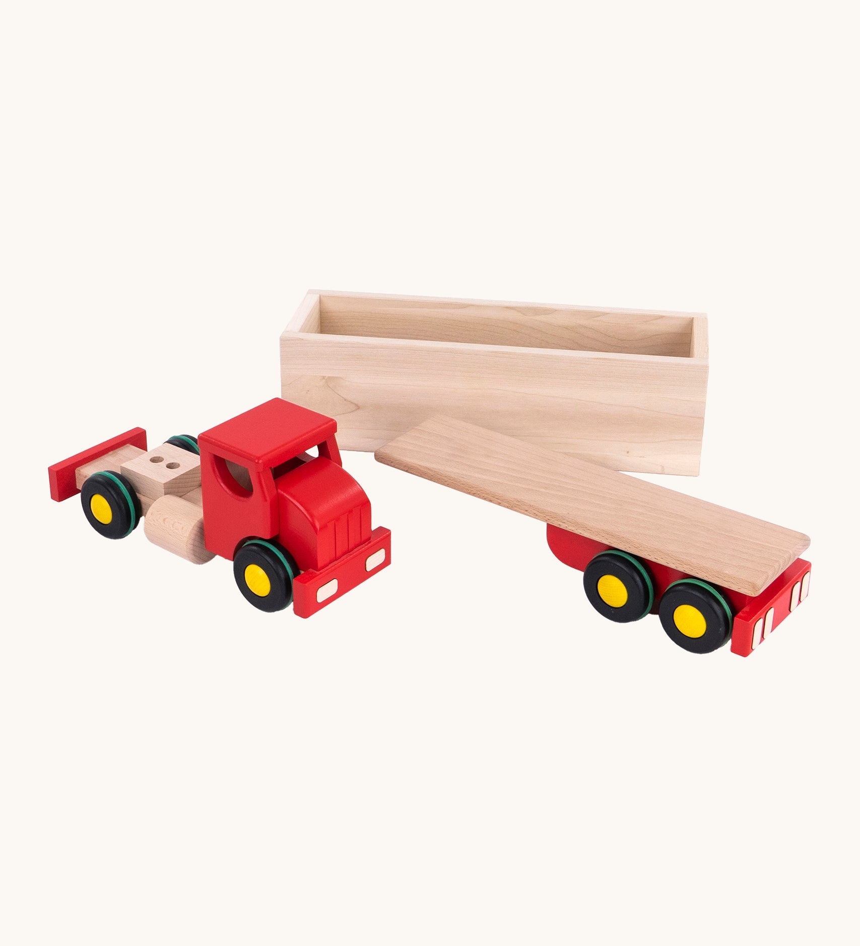 The Bajo Large Truck & Trailer in its 3 parts of one wooden cab, one wooden box trailer and one wooden base for the box trailer to attach on to. The image is on a cream background