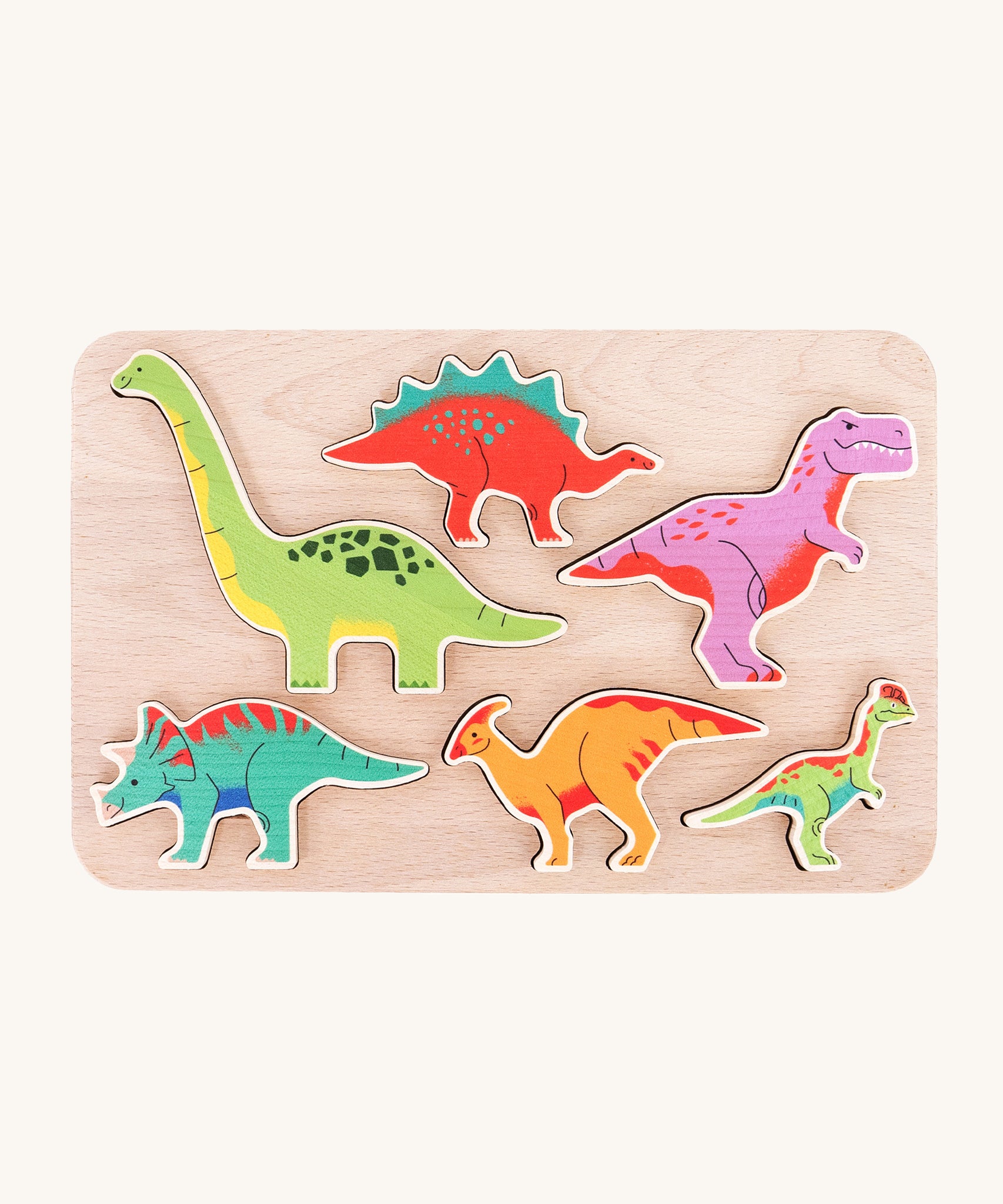 The Bajo Wooden Dinosaur Puzzle, has 6 colourful wooden dinosaurs that slot into a light wooden base. The pieces can also be used as a stand alone in Jurassic play scenes. The image is taken from a top down view to show the dinosaurs in their base 