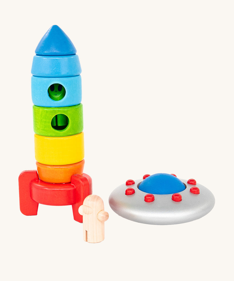 The Bajo Alien Flying Saucer has landed next to a rainbow Bajo Rocket. The green alien is inside the astronaut's rainbow rocket and the astronaut is stood outside